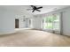 Spacious living room with large windows and a sliding glass door to the outside at 4904 N Tillotson Ave, Muncie, IN 47304