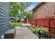 Landscaped backyard with patio, outdoor seating, flower beds, lush lawn, and string lights at 519 Woodruff Place Middle Dr, Indianapolis, IN 46201