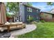 Inviting backyard patio featuring a seating area, landscaping, lush grass, and a grill at 519 Woodruff Place Middle Dr, Indianapolis, IN 46201