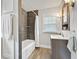 Updated bathroom features a shower with a tiled backsplash, a window, and modern fixtures at 519 Woodruff Place Middle Dr, Indianapolis, IN 46201