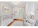 Peaceful Bedroom featuring a crib, dresser, and cozy rocking chair, perfect for a new baby at 519 Woodruff Place Middle Dr, Indianapolis, IN 46201