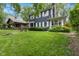 Traditional home with a lush green lawn and mature trees at 519 Woodruff Place Middle Dr, Indianapolis, IN 46201