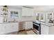 Stylish kitchen with white cabinets, stainless steel appliances, granite counters, and a subway tile backsplash at 519 Woodruff Place Middle Dr, Indianapolis, IN 46201