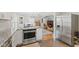 Modern kitchen showcasing stainless steel appliances, granite countertops, and an open layout leading to the living area at 519 Woodruff Place Middle Dr, Indianapolis, IN 46201