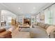 Open living room with a fireplace, large sectional sofa, and hardwood floors at 519 Woodruff Place Middle Dr, Indianapolis, IN 46201