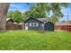 Backyard features a charming outbuilding, storage shed, fire pit, and grassy lawn at 519 Woodruff Place Middle Dr, Indianapolis, IN 46201