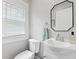 Powder room featuring modern fixtures, a stylish mirror, and natural light at 519 Woodruff Place Middle Dr, Indianapolis, IN 46201