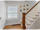 Classic staircase design with hardwood steps and white railings, complemented by framed artwork at 519 Woodruff Place Middle Dr, Indianapolis, IN 46201