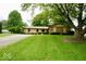 Charming single-story home with stone facade, mature trees, and well-manicured lawn at 5331 Birch Ln, Greenwood, IN 46143