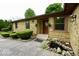 Inviting front entrance of a stone home with a decorative pond and manicured bushes at 5331 Birch Ln, Greenwood, IN 46143