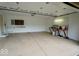 Spacious garage with white walls, storage shelves, workbench, and ample room for parking and projects at 5331 Birch Ln, Greenwood, IN 46143