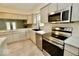 This kitchen features white cabinets, stainless appliances, and a view into the next room through glass paneled doors at 5331 Birch Ln, Greenwood, IN 46143