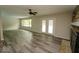 Bright living room featuring wood flooring, ceiling fan, fireplace, and natural light from windows and french doors at 5331 Birch Ln, Greenwood, IN 46143
