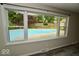 The beautiful backyard pool area, complete with surrounding trees and lush greenery, is visible from inside this home at 5331 Birch Ln, Greenwood, IN 46143