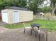 Backyard view with patio, lawn, privacy fence, and detached garage at 5348 Crittenden Ave, Indianapolis, IN 46220
