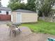 Backyard with patio, detached garage, and lush greenery, great for outdoor enjoyment at 5348 Crittenden Ave, Indianapolis, IN 46220