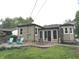 Home's back yard shows a concrete patio, lawn, chairs, and trees, with garage partially visible at 5348 Crittenden Ave, Indianapolis, IN 46220