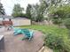 Serene backyard featuring a patio, lush lawn, privacy fence, and detached garage at 5348 Crittenden Ave, Indianapolis, IN 46220
