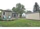 Home's backyard shows a concrete patio, lawn, chairs, and a detached garage at 5348 Crittenden Ave, Indianapolis, IN 46220