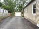Side view of home showcasing driveway and garage, alongside partial view of home's exterior at 5348 Crittenden Ave, Indianapolis, IN 46220