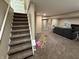 Finished basement featuring carpeted stairs and floor, adjacent to a living room at 5348 Crittenden Ave, Indianapolis, IN 46220