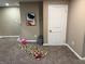 Finished basement area with a white door, gray accents and a work out mat at 5348 Crittenden Ave, Indianapolis, IN 46220