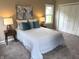 Bedroom with large bed, carpeted floor, neutral colored walls, and lamps at 5348 Crittenden Ave, Indianapolis, IN 46220