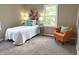 Bedroom with large bed, carpeted floor, neutral colored walls, chair, and bright natural light at 5348 Crittenden Ave, Indianapolis, IN 46220