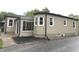 Back view of home with vinyl siding, a concrete patio, and a small garden bed at 5348 Crittenden Ave, Indianapolis, IN 46220