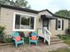 Inviting front exterior with a pair of blue chairs and bright orange pillows at 5348 Crittenden Ave, Indianapolis, IN 46220