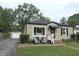 Charming single-story home featuring tidy landscaping and detached garage at 5348 Crittenden Ave, Indianapolis, IN 46220