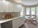 Spacious kitchen with white cabinets, stainless steel appliances, granite countertops, and hardwood floors at 5348 Crittenden Ave, Indianapolis, IN 46220