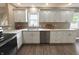 Spacious kitchen with white cabinets, stainless steel appliances, granite countertops, and hardwood floors at 5348 Crittenden Ave, Indianapolis, IN 46220