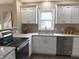 Well-lit kitchen with granite countertops, stainless steel oven, white cabinets, and stainless steel appliances at 5348 Crittenden Ave, Indianapolis, IN 46220