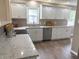 Spacious kitchen with white cabinets, stainless steel appliances, granite countertops, and hardwood floors at 5348 Crittenden Ave, Indianapolis, IN 46220