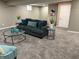 Cozy finished basement living room featuring a soft couch, carpeted floors and neutral paint at 5348 Crittenden Ave, Indianapolis, IN 46220