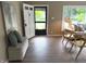 View of the entryway, featuring a seating bench and light-colored wood flooring at 5348 Crittenden Ave, Indianapolis, IN 46220