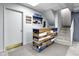 Basement area features a custom bar with a wood design and tiled floors, next to staircase at 5543 N Pennsylvania N St, Indianapolis, IN 46220
