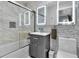 This bathroom features a bathtub with glass doors and a sink with storage at 5543 N Pennsylvania N St, Indianapolis, IN 46220