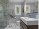 This is a bathroom featuring a glass shower with decorative tile and a modern sink with wooden cabinets at 5543 N Pennsylvania N St, Indianapolis, IN 46220
