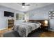 This bedroom features a ceiling fan, window, and a queen bed at 5543 N Pennsylvania N St, Indianapolis, IN 46220