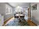 Bright dining room with modern chandelier, wood table, and an opening into the kitchen area at 5543 N Pennsylvania N St, Indianapolis, IN 46220