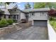 Charming grey home featuring a well-manicured lawn, beautiful landscaping, and an attached garage at 5543 N Pennsylvania N St, Indianapolis, IN 46220