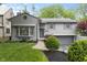 Charming two-story home with landscaped front yard, updated exterior, brick walkway, and attached two car garage at 5543 N Pennsylvania N St, Indianapolis, IN 46220