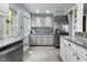 Kitchen with stainless steel appliances, gray cabinets, and open design at 5543 N Pennsylvania N St, Indianapolis, IN 46220