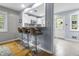 Charming kitchen pass-through with counter seating and access to white cabinets at 5543 N Pennsylvania N St, Indianapolis, IN 46220