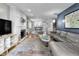 Open living room with fireplace, tv area, hardwood floors, and open access to the kitchen and dining room at 5543 N Pennsylvania N St, Indianapolis, IN 46220