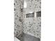 This shower features decorative tile and a built-in shelf at 5543 N Pennsylvania N St, Indianapolis, IN 46220