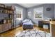 This sitting room features hardwood floors, a chair, and a bookshelf at 5543 N Pennsylvania N St, Indianapolis, IN 46220