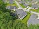 Aerial view of a home with screened in porch, mature landscaping and well-maintained lawn at 5572 Harness Dr, Greenwood, IN 46143